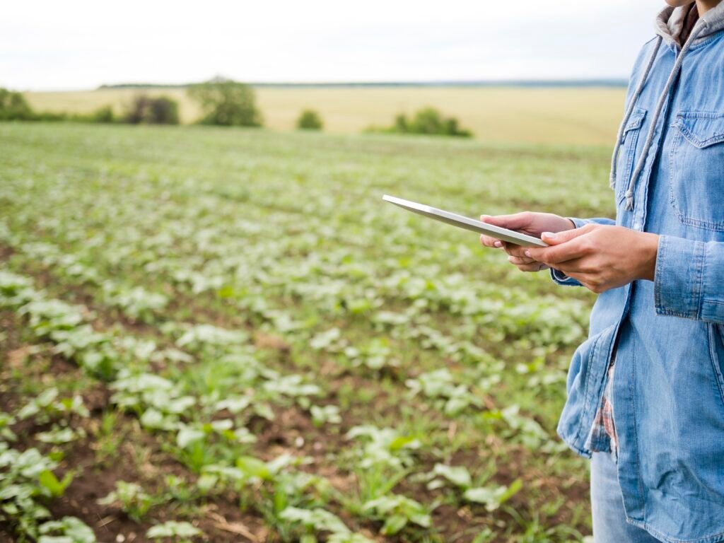 woman-holding-tablet-farm-field-with-copy-space